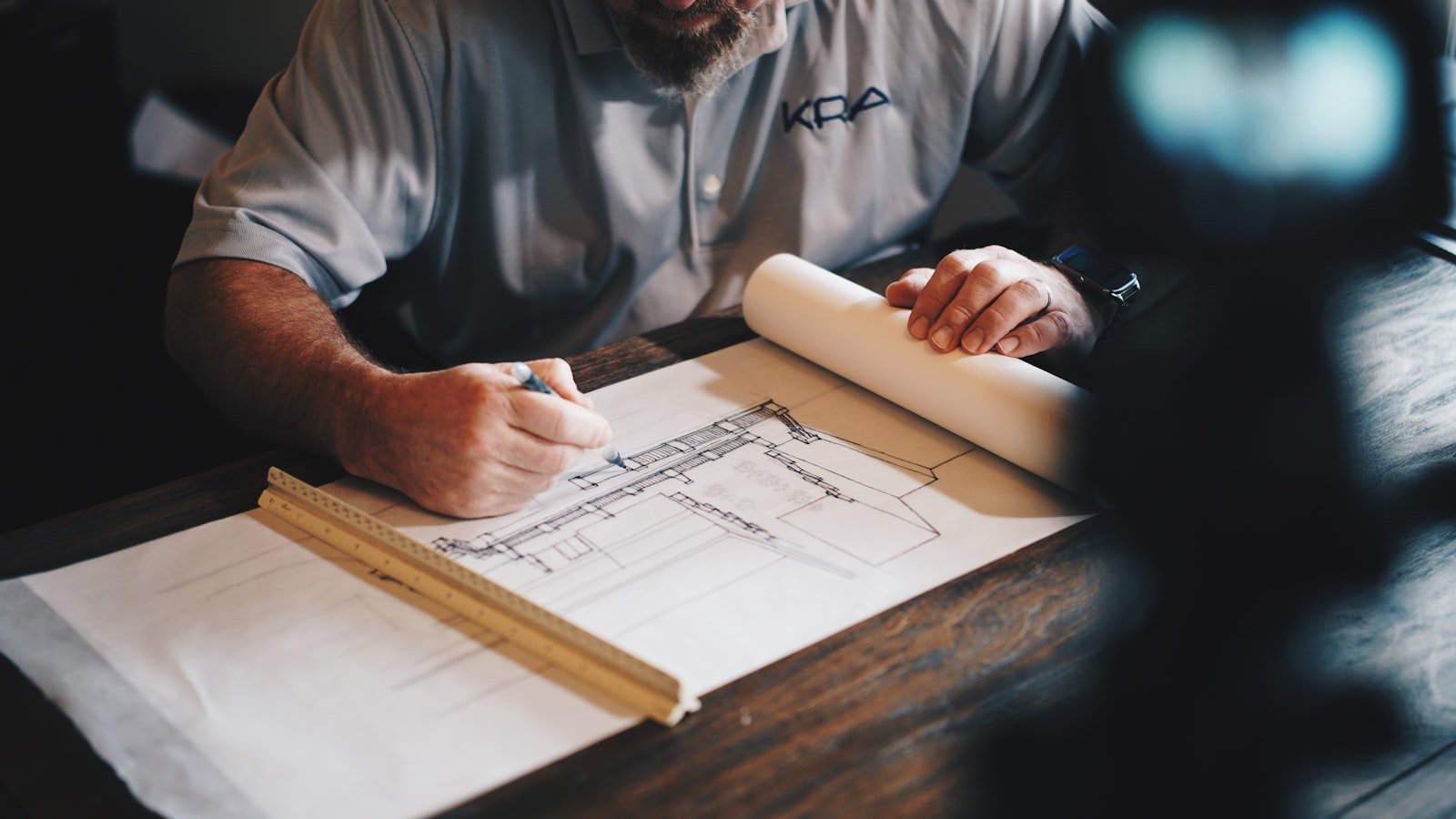 Contractor marking up a set of drawings with a scale ruler