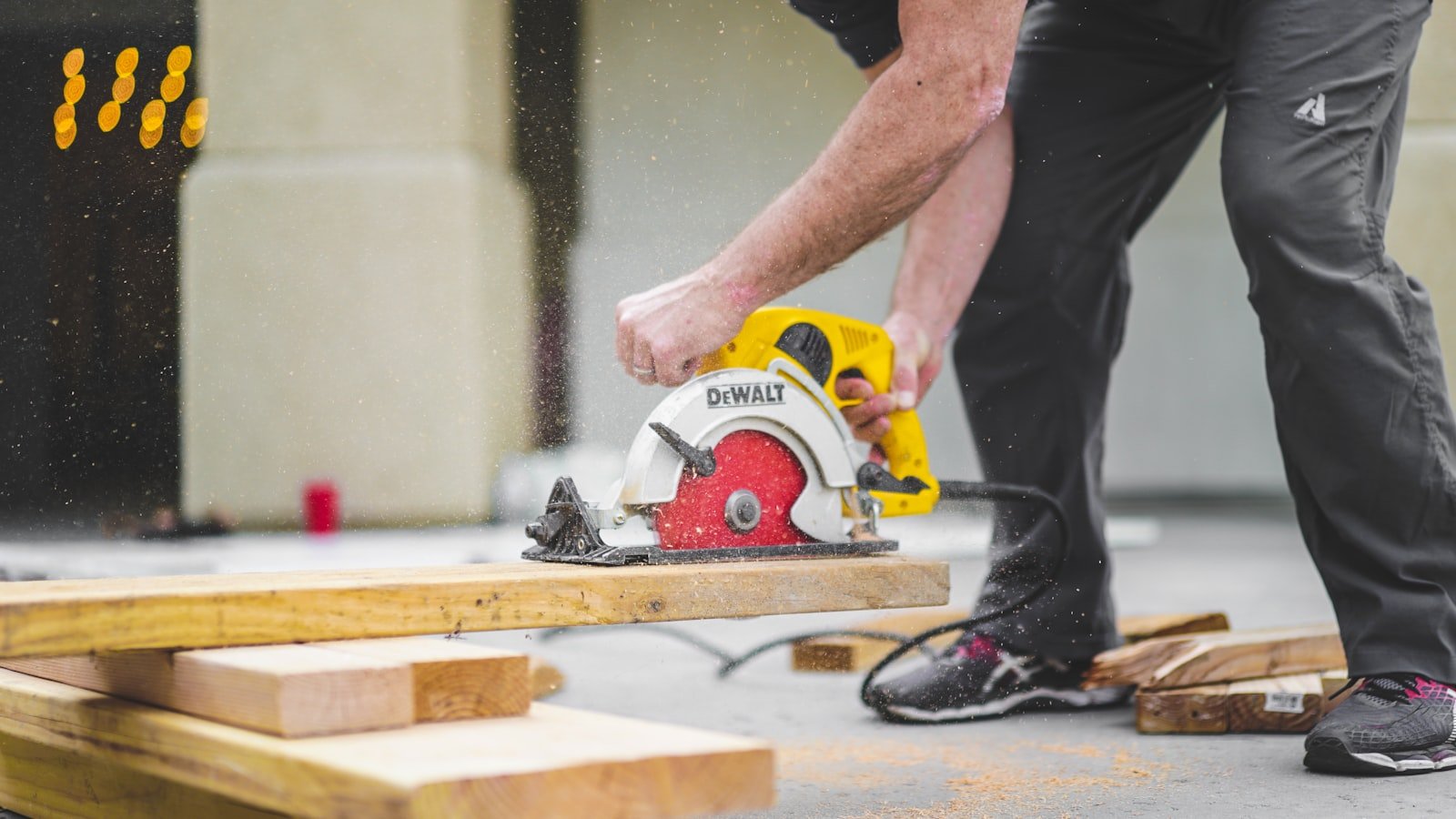 Carpenter cutting framing lumber with a circular saw